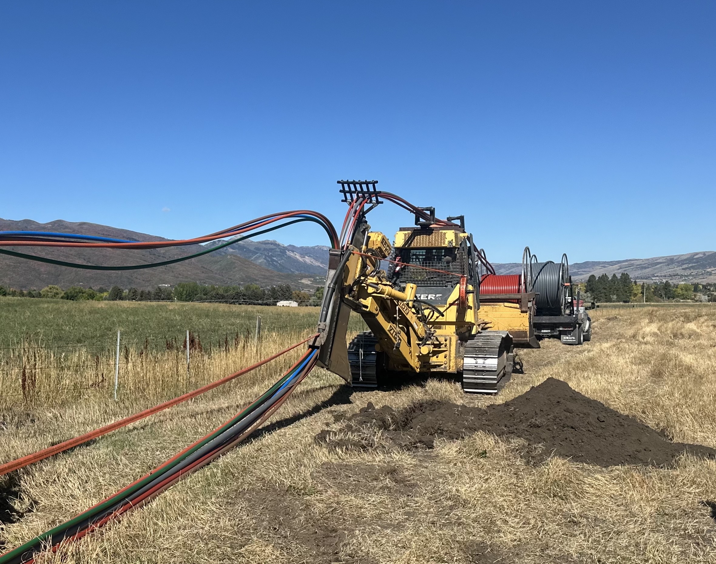 HDPE conduit being plowed in open terrain