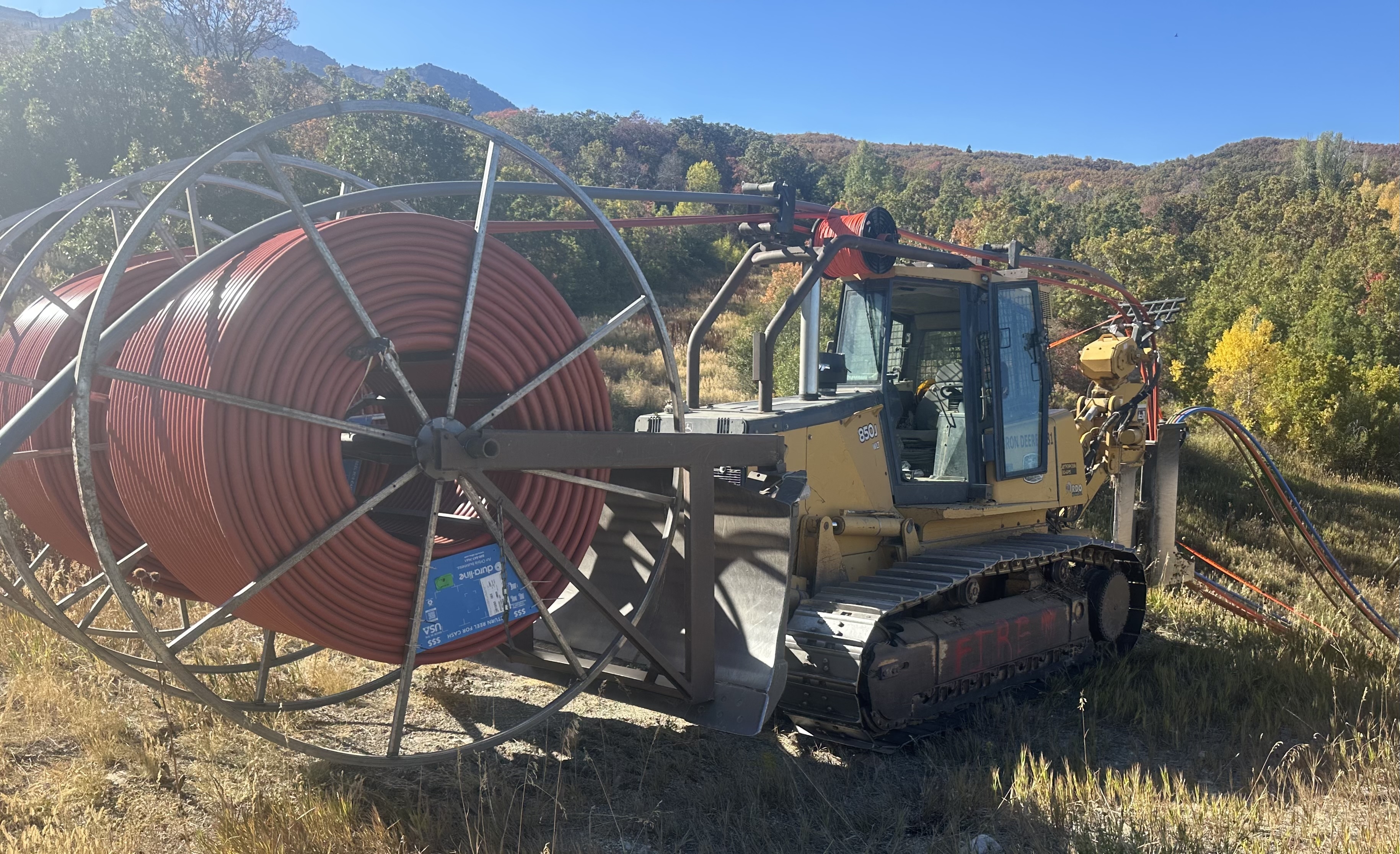 Dozer loaded with HDPE reel on a rural jobsite